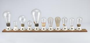 eleven light bulbs on a plank