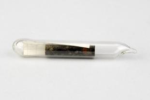 mineral sample in sealed glass tube