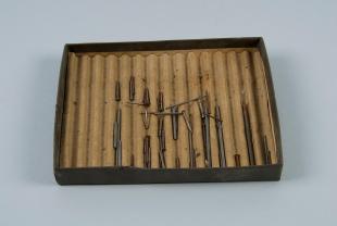 box of magnetized iron rods and nails